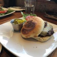 Saloon Burger · White cheddar, stout braised onions, grandma brown's pickles and the sauce.