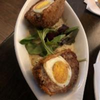 Scotch Egg · Hardboiled egg wrapped in seasoned sausage, breaded, deep-fried and served with Dijon mustar...