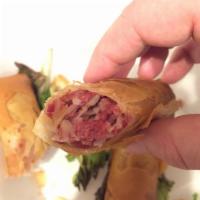 Reuben Spring Rolls · Top-quality tender corned beef, Swiss cheese, and sauerkraut hand wrapped in a spring roll, ...