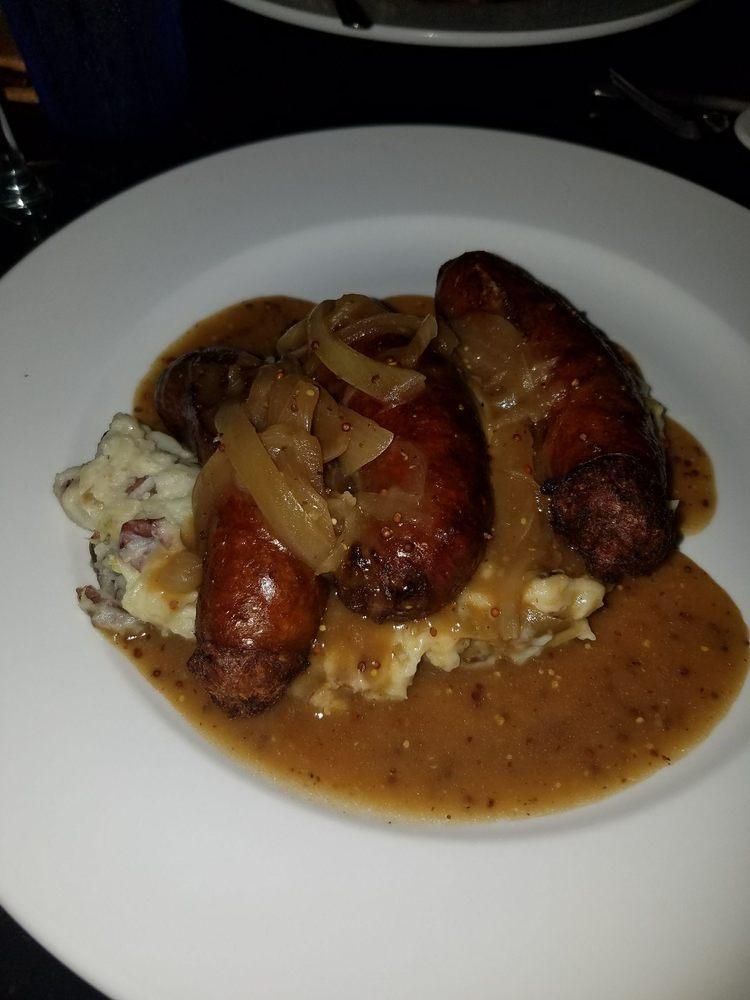 Bangers and Mash · Irish pork sausages, topped with Guinness onion gravy, served with colcannon potatoes and baked beans.