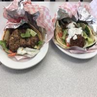 Falafel Pita · Falafel topped with lettuce, tomato,onion, cucombe our tzatziki sauce and hummus placed insi...