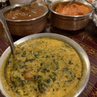 Saag Paneer · Fresh spinach and paneer cooked with garlic, onion, ginger, and spices in a creamy sauce. 