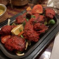 Chicken Tandoori · Marinated Chicken leg quarter in Nepal sauces and barbecued in tandoori oven ( serve with fr...