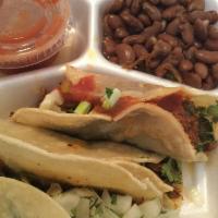 Tacos · 2 deep-fried corn tortillas filled with chicken, beef, or pork, lettuce, tomatoes, Mexican c...