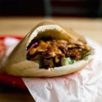Chicken Shawarma Pita · Pita sandwich with meat, toppings and sauce.