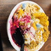 Tropical Bowl · Organic Acai blended with coconut milk and banana topped with sliced banana, fresh mango, gl...