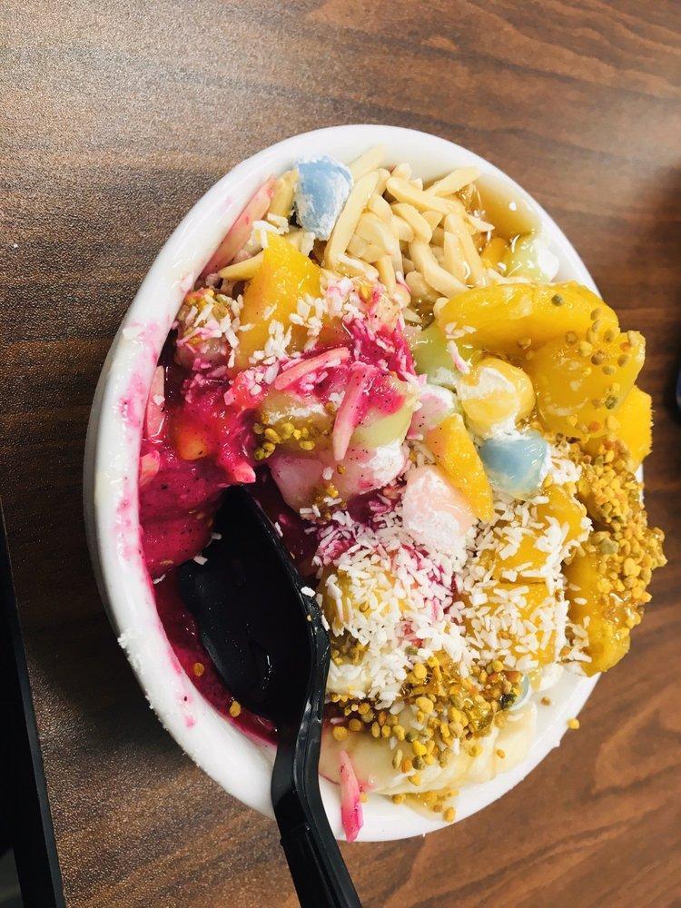 Tropical Bowl · Organic Acai blended with coconut milk and banana topped with sliced banana, fresh mango, gluten free granola, and local honey.