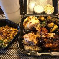 The Garlic Chicken Plate · 1/2 Butter garlic roasted chicken on a bed of White rice and side of  Brussels sprouts. Serv...