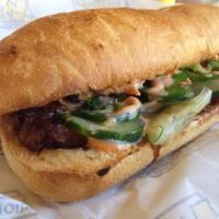 Banh Mi · Soy glazed pulled pork, sliced cucumbers, pickled carrots, jalapenos and fresh cilantro, wit...