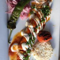 Beyti · Char grilled grounded lamb wrapped in thin lavash bread cut in bite sizes topped with yogurt...