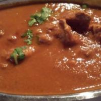 Lamb Curry · Tender pieces of lamb in a mildly spice sauce. Served with basmati jeera rice and a choice o...