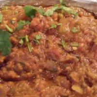 Bhartha · Baked and mashed eggplant seasoned with herbs and sauteed with tomatoes, onions and green pe...