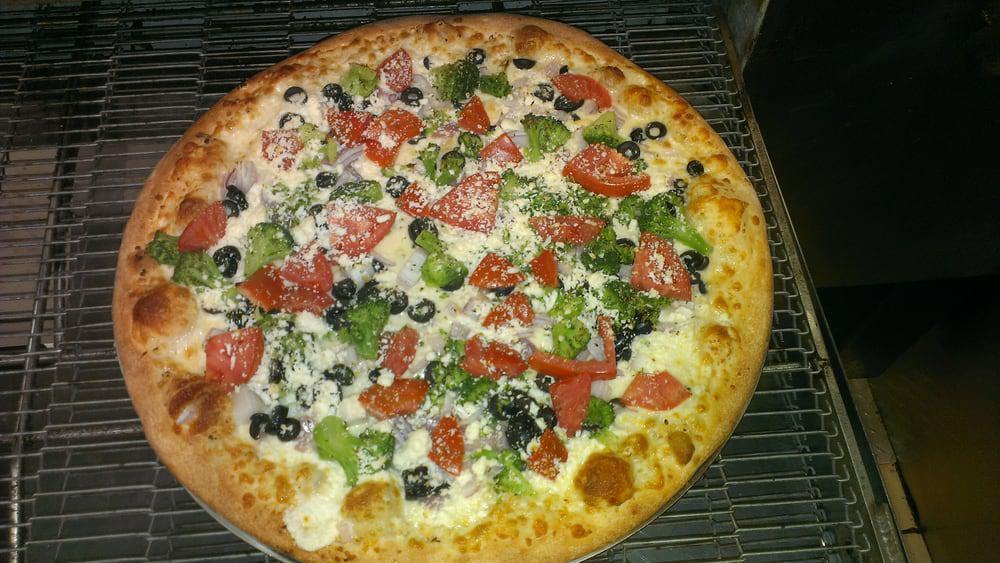 Mediterranean Pizza · No sauce, mozzarella cheese, fresh garlic, feta, black olives, tomatoes, red onions, and broccoli on Italian thin crust pizza.