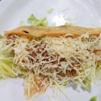 Shredded Beef Crispy Taco · Lettuce, cheese and tomato sauce.