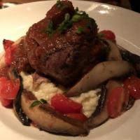 Pork Osso Bucco · Slowly braised, served over Parmesan risotto with mushrooms and roasted vegetables- topped w...
