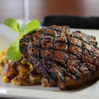 Grilled Pork Porterhouse · Topped with bourbon-cherry compote and pistachio granola with smashed potatoes and sauteed s...