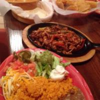 Chicken Fajitas · Fresh grilled peppers, onions and chicken served sizzling with two flour tortillas, sour cre...