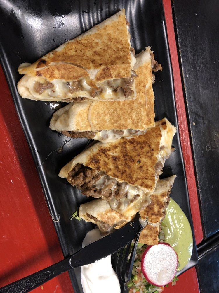 Grilled Steak Quesadilla · Served in a flour or whole wheat tortilla with melted mozzarella cheese and pico de gallo. Includes sour cream and guacamole on the side.