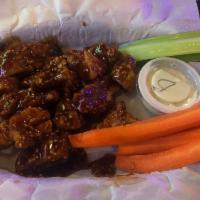 Boneless Wings · Breaded chicken breast baked chopped tossed and sauced. Served with carrots, celery, and cho...