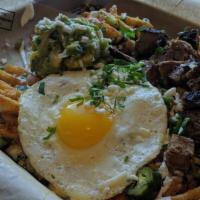 Trash Frys · Waffle fries, sunny side up egg, cheddar Jack blend queso, pico, jalapenos, tequila crema an...
