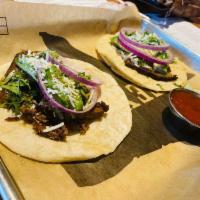 Smoked Brisket Tacos · Brisket rubbed with our special spice and slow-smoked with fresh red onion, julienned avocad...