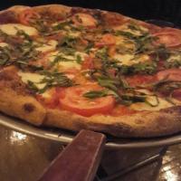 Margarita Pizza · Tomato sauce, garlic olive oil, fresh mozzarella, tomatoes and basil.