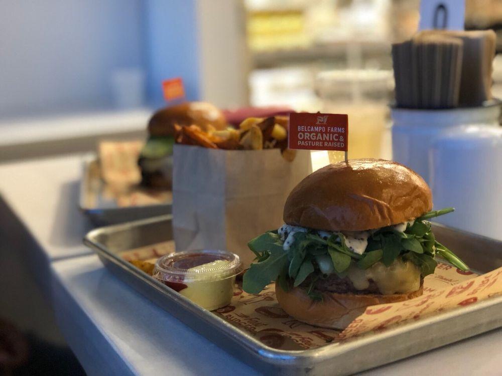 Belcampo Burger · ½ LB Grass-Fed & Finished 28 Day Dry-Aged Belcampo Beef, White Cheddar, Caramelized Onion, Butter Lettuce, House Sauce. Served on a Brioche Bun.
