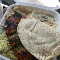 Chicken Kabob Plate · Grilled chicken breast and Mediterranean seasoning. Plate served with rice, salad and hummus.