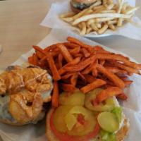 The Surf and Turf Burger · A juicy beef patty covered with Swiss cheese. Topped with fried shrimp. Dressed with remoula...