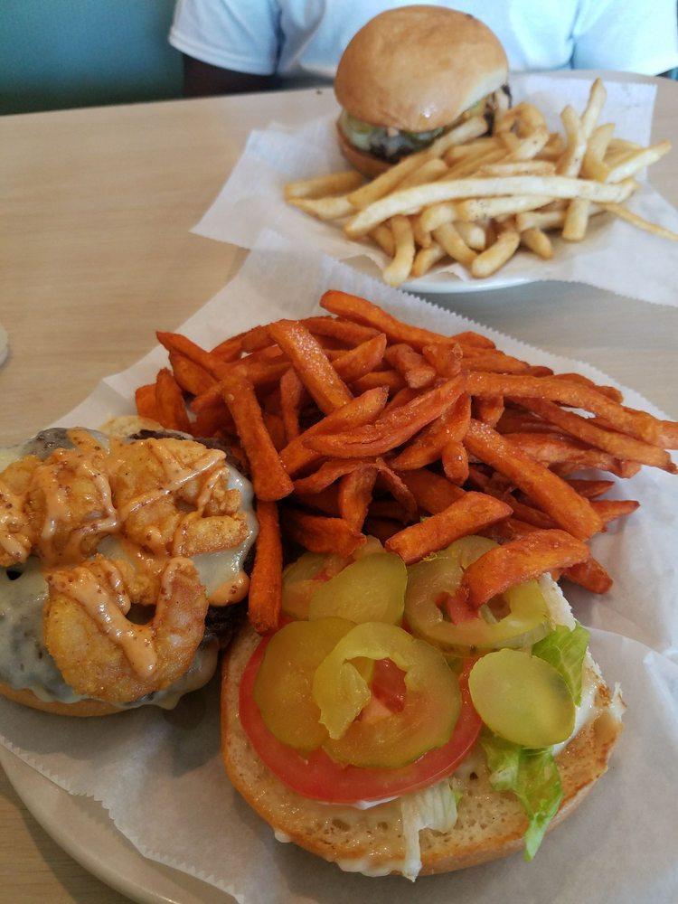 The Surf and Turf Burger · A juicy beef patty covered with Swiss cheese. Topped with fried shrimp. Dressed with remoulade, lettuce, tomatoes and pickles on choice of bread. Served with choice of side.