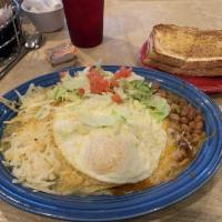 Breakfast Enchiladas · Enchiladas, hash browns, beans, with red or green chile, topped with 2 eggs any style, chedd...