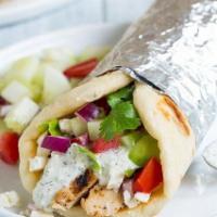 Chicken Wrap · Marinated chicken slices wrapped in a soft pita with fresh onions, tomatoes, tzatziki, and t...