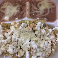 Chilaquiles · Sauteed tortillas with salsa, served with beans (chilaquiles servido con frijoles).