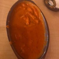 Butter Chicken · Boneless chicken cooked in a delicious blend of cream and tomato sauce.
