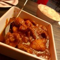 Lamb Vindaloo · Tender lamb marinated and cooked with spices along with potatoes.