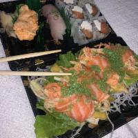 Golden Salmon · Spicy crabmeat, mango and cucumber inside wrapped with salmon sashimi.