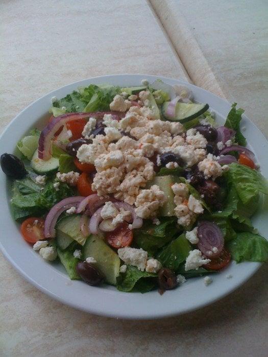 Greek Salad · Romaine lettuce, red onions, tomatoes, cucumber, and feta cheese in vinaigrette dressing with kalamata olives.