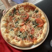 Margarita Pizza · Fresh tomatoes, roasted garlic, fresh basil and mozzarella cheese drizzled with extra virgin...