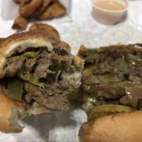 Peppered Cheesesteak · Sirloin steak, grilled onions, and American Swiss kicked with jalapenos, banana peppers and ...