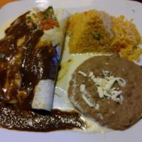 Burrito De La Roqueta · 2 soft flour tortillas filled with an exquisite choice of chicken or pork, topped with cream...