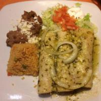 Enchiladas Verdes · Green Verde sauce softly coat 3 delicious, savory chicken enchiladas, topped with cheese and...