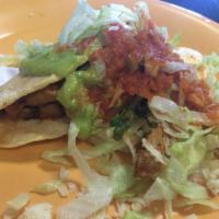 Crispy Taco · Guacamole, sour cream, cheese, lettuce, pico de gallo, salsa and your choice of meat on a ha...