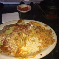 Beef Enchiladas · Topped with chili gravy and cheese. Served with Spanish rice and refried beans.