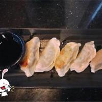 Gyoza · Pan-fried dumplings stuffed with pork and vegetables.