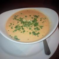 Lobster Bisque Soup · Fresh herbs, cream and sherry in a rich stock.