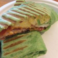Wrap with a Kick · Cage free eggs, smoked bacon, black beans, aged cheddar cheese, tomato, red onion with our c...