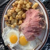 Sliced Corned Beef and Eggs Breakfast · Served with potatoes and toast.
