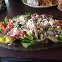 Greek Salad · Romaine lettuce, tomato, cucumber, red onion topped with feta cheese, Kalamata olives, peppe...