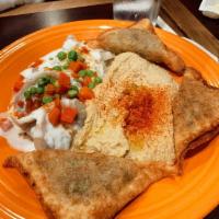 Sambosa · Fried crispy turnovers stuffed with ground beef and chickpeas, served with chutney.