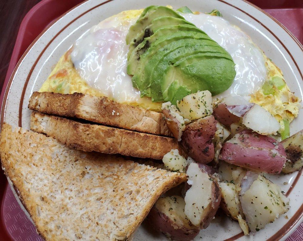 Veggie Omelette · Bell peppers, onions, tomatoes, and mushrooms topped with avocado.  Choice of 3 slices of cheese.  Also comes with home fries and choice of toast.